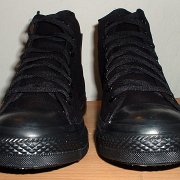 Monochrome Black Chucks  New black monochrome high tops, made in China, front view.