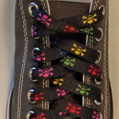 Multi Color Skulls Shoelaces on Chucks  Multi-colored shoelace on a charcoal grey low top chuck.