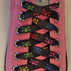 Multi Color Skulls Shoelaces on Chucks  Multi-colored shoelace on a pink low top chuck.