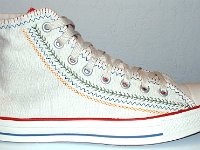 Multicultural High Top Chucks  Outside view of a right parchment with red, blue, and orange trim multicultural high top.