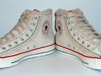 Multicultural High Top Chucks  Angled front view of parchment with red, blue, and orange trim multicultural high tops.