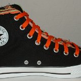 Multilayer High Top Chucks  Inside patch view of a left black multilayered high top with orange laces.