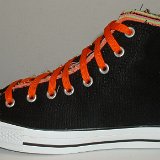 Multilayer High Top Chucks  Outside view of a left black multilayered high top with orange laces.