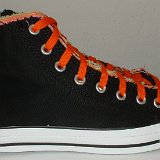 Multilayer High Top Chucks  Outside view of a right black multilayered high top with orange laces.