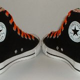 Multilayer High Top Chucks  Angled rear view of black multilayered high tops with orange laces.