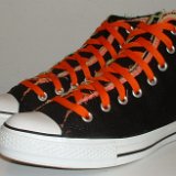 Multilayer High Top Chucks  Angled side view of black multilayered high tops with orange laces.