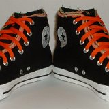 Multilayer High Top Chucks  Angled front view of black multilayered high tops with orange laces.