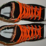 Multilayer High Top Chucks  Top view of black multilayered high tops with orange laces.