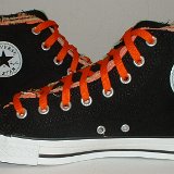 Multilayer High Top Chucks  Inside patch views of black multilayered high tops with orange laces.