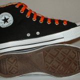 Multilayer High Top Chucks  Inside patch and outer sole views of black multilayered high tops with orange laces.