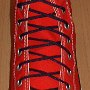 Narrow Round Shoelaces  Red high top with narrow navy blue laces.