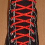 Narrow Round Shoelaces  Black high top with narrow red shoelaces.