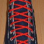 Narrow Round Shoelaces  Navy blue high top with narrow red laces.