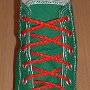 Narrow Round Shoelaces  Celtic green high top with narrow red laces.