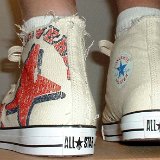 Natural (Unbleached) White High Top Chucks  Wearing graphic star high tops, rear view.