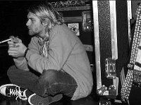 Kurt Cobain and Nirvana  Kurt seated and wearing black chucks.