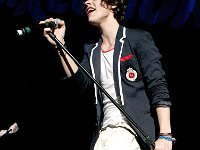 One Direction  Harry Styles performing in red low cut chucks.