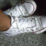 Optical White High Top Chucks  Wearing criss-cross laced optical white high top chucks.