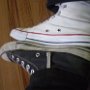 Optical White High Top Chucks  Optical white high top contrasted with a black high top.