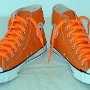 Orange Chucks  Orange flame high tops with orange laces, angled front view.