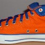 Orange Chucks  Inside patch view of a right orange and royal blue high top rolled down to the seventh eyelet.