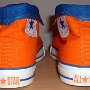 Orange Chucks  Rear view of orange and royal blue high tops rolled down to the seventh eyelet.