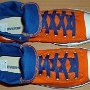 Orange Chucks  Top view of orange and royal blue high tops rolled down to the seventh eyelet.