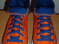 Orange and Royal Foldover High Top Chucks  Angled front and top view of orange and royal blue high tops rolled down to the seventh eyelet.