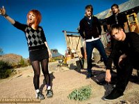 Paramore  Casual band photo. Hayley Williams is wearing high top chucks.