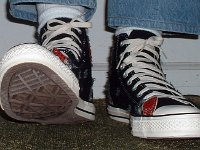 Patchwork High Top and Low Cut Chucks  Stepping out in black ptaches high tops, front view.