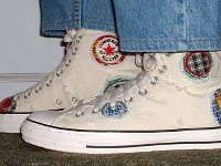 Chuck Taylor PatchworkPatchwork High Top and Low Cut Chucks  Wearing white patches high tops, side view.