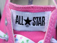Pink High Top and Low Cut Chucks  Close up of the license plate logo patch on pink low cut chucks.