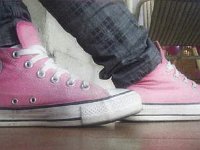 Pink High Top and Low Cut Chucks  Wearing pink high top chucks, side view.