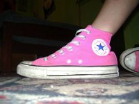 Pink High Top and Low Cut Chucks  Seated wearing pink high top chucks.