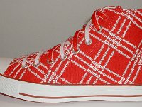 Product Red High Top Chucks  Outside view of a left Product Red high top with red and white reversible shoelaces.