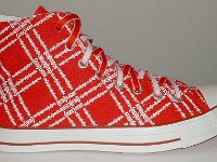 Product Red High Top Chucks  Outside view of a right Product Red high top with red and white reversible shoelaces.