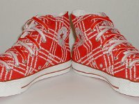 Product Red High Top Chucks  Angled front view of Product Red high tops with red and white reversible shoelaces.