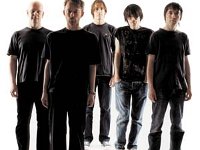 RadioHead  Radiohead band members stand together in a posed photo.