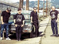 Tim Armstrong  Rancid outside posed in front of a classic car.