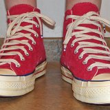 Red Chuck 70 Vintage Canvas High Tops  Wearing red Chuck 70 vintage canvas high tops, front view 1.