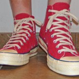 Red Chuck 70 Vintage Canvas High Tops  Wearing red Chuck 70 vintage canvas high tops, front view 2.