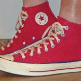 Red Chuck 70 Vintage Canvas High TopsRed Chuck 70 Vintage Canvas High Tops  Wearing red Chuck 70 vintage canvas high tops, left side view.