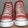 Red High Top Chucks  Front view of distressed red high tops.