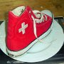 Red High Top Chucks  Right red high top chuck with the Swiss flag emblem on the outside.