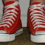 Red High Top Chucks  Wearing red high top chucks, front view.