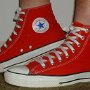 Red High Top Chucks  Wearing red high top chucks,left side view.