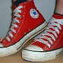 Red High Top Chucks  Wearing red high tops with wide laces, angled side view.