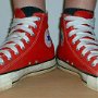 Red High Top Chucks  Wearing red high tops with wide laces, angled front view.