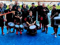 Red Hot Chili Pipers  Casual shot of the band before a performance at a soccer field.
