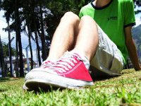 Red Low Cut Chucks  Seated on the grass wearing red low cut chucks.